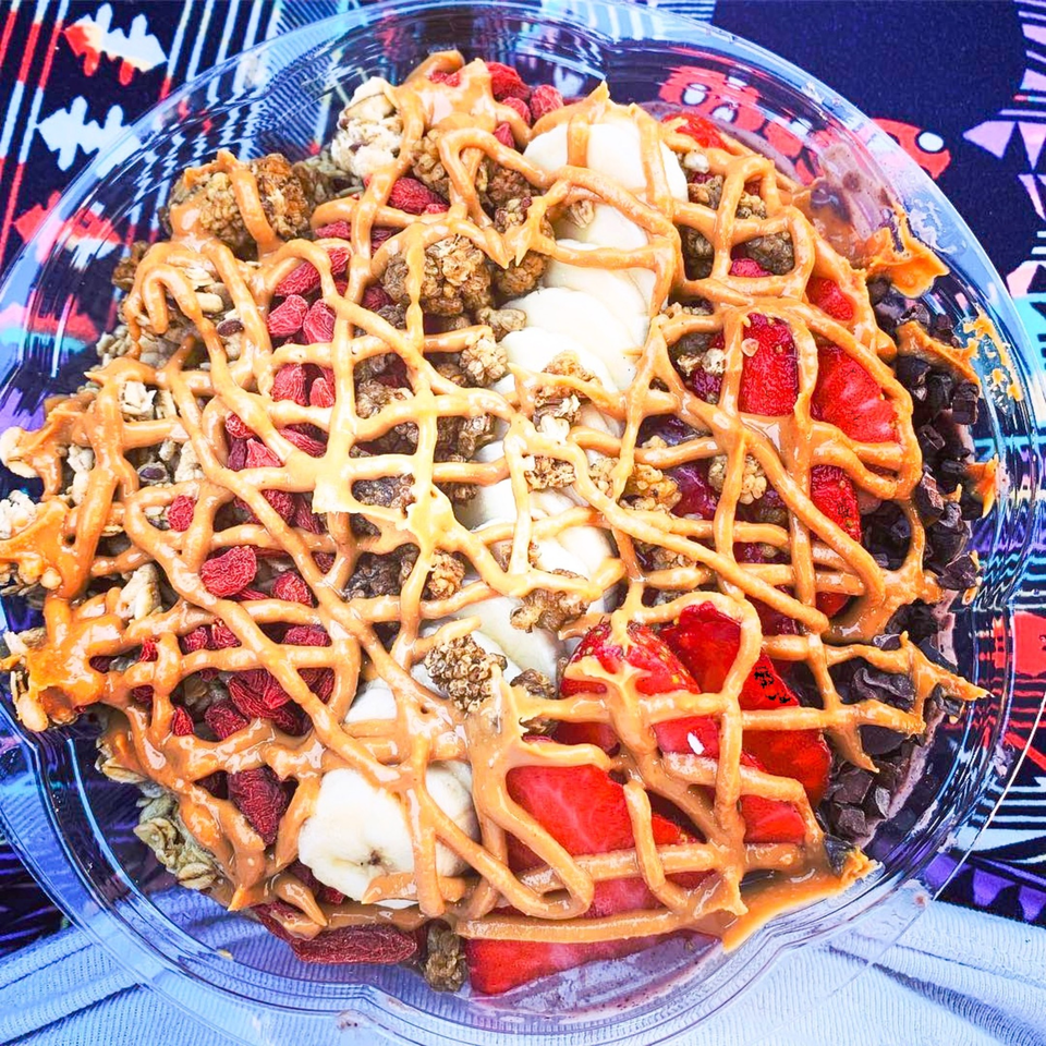 Juice Parlor NoHo's acai bowl with bananas, strawberries, goji berries, granola, chocolate chips, and peanut butter drizzle.
